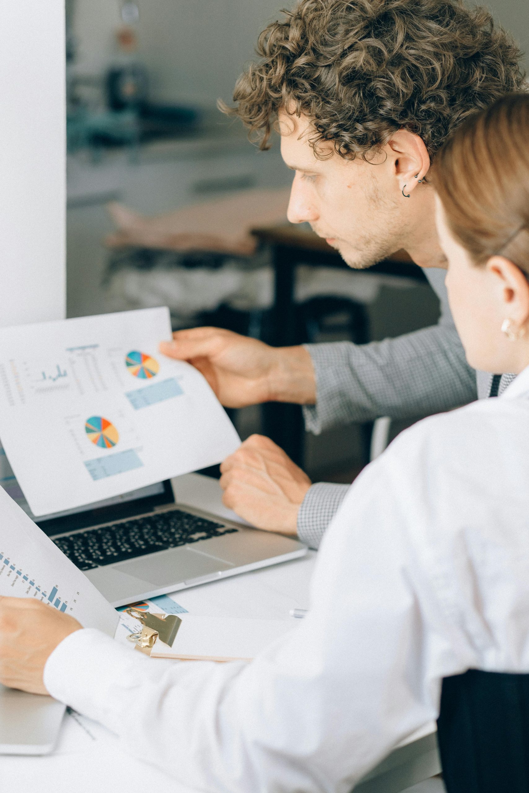 Digital Dawn - man and women looking at printed paper chart